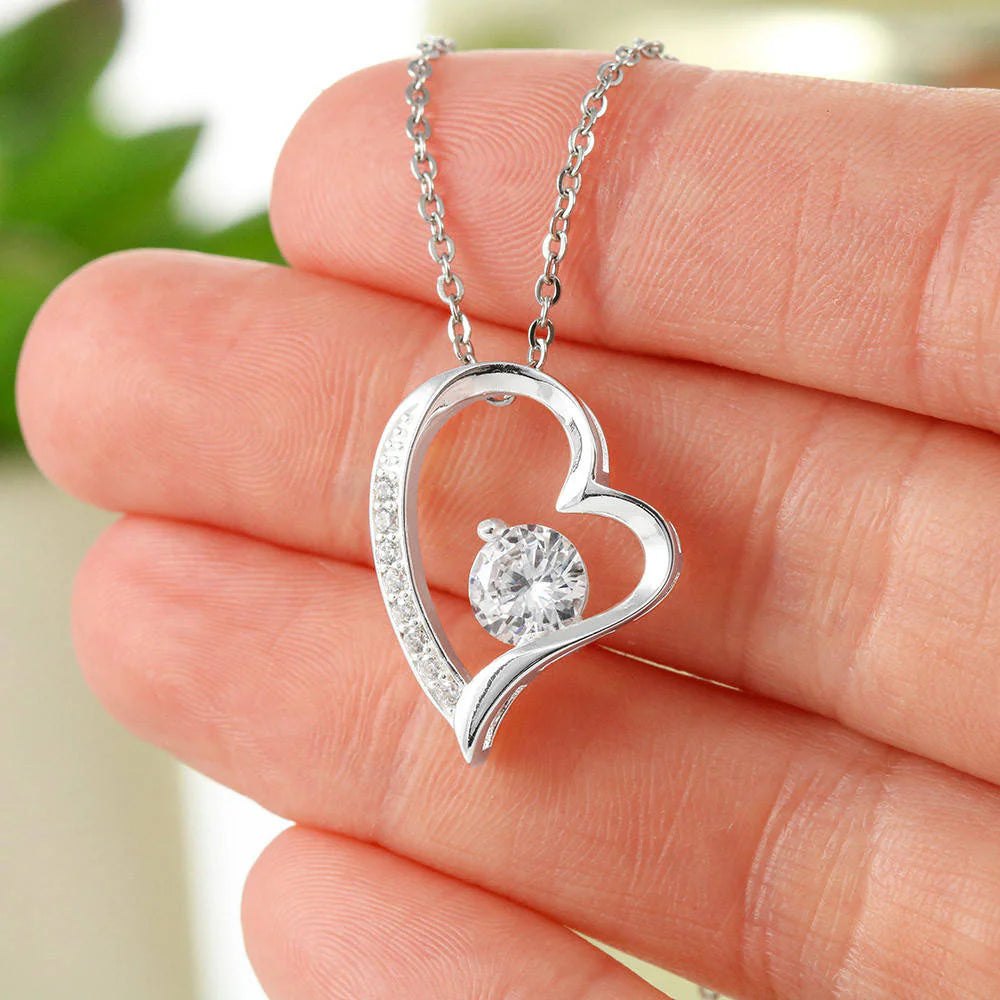 mom wearing heart necklace gift from daughter